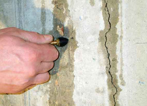 basement wall being waterproofed